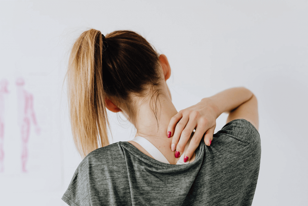 female with shoulder blade pain and headaches